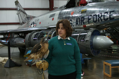 Mary Beth and Dakota, the red-tailed hawk, at Open Cockpit Day at the New England Air Museum.