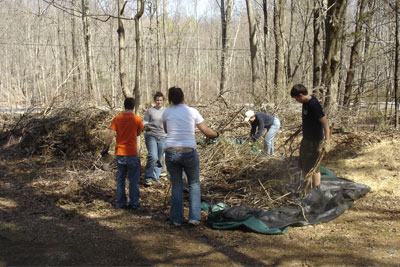Members of the Alpha Phi Omega Delta Sigma fraternity helping with cleanup.