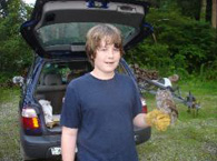 Volunteer Galen Riordan holding and eastern screech owl.